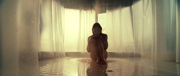 Movie still from “Blade: Trinity” (2004), directed by David S. Goyer – A woman sitting on the ground in front of a window; Wide shot, High angle