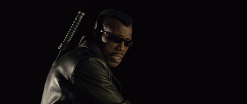 Movie still from “Blade: Trinity” (2004), directed by David S. Goyer – A man in a leather jacket holding a samurai sword; Close Up shot, Low angle