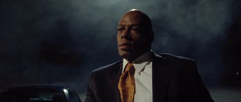 Movie still from “Blade: Trinity” (2004), directed by David S. Goyer – A man in a suit and tie looking to his left; Close Up shot, Low angle