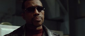 Movie still from “Blade: Trinity” (2004), directed by David S. Goyer – A person wearing sunglasses and a leather jacket; Close Up shot, Low angle