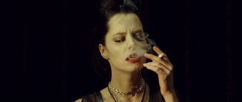 Movie still from “Blade: Trinity” (2004), directed by David S. Goyer – A woman smoking a cigarette while wearing a necklace; Close Up shot, Low angle