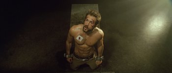 Movie still from “Blade: Trinity” (2004), directed by David S. Goyer – A shirtless man with bandages on his arms and legs; Medium shot, Overhead angle