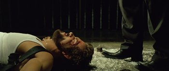 Movie still from “Blade: Trinity” (2004), directed by David S. Goyer – A man laying on the ground with blood on his face; Close Up shot, Over the shoulder angle