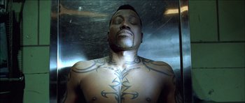 Movie still from “Blade: Trinity” (2004), directed by David S. Goyer – A man that has a tattoo on his chest; Close Up shot, Overhead angle