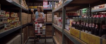 Movie still from “Blast from the Past” (1999), directed by Hugh Wilson – A woman and a child in a grocery store; Wide shot, Over the shoulder angle