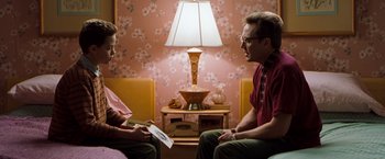 Movie still from “Blast from the Past” (1999), directed by Hugh Wilson – A man and a woman are sitting in a room talking; Medium shot, Over the shoulder angle