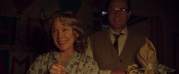 Movie still from “Blast from the Past” (1999), directed by Hugh Wilson – A man and a woman smiling for the camera; Medium shot, Low angle