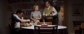Movie still from “Blast from the Past” (1999), directed by Hugh Wilson – A man and a woman standing in front of a cake; Medium shot, Over the shoulder angle