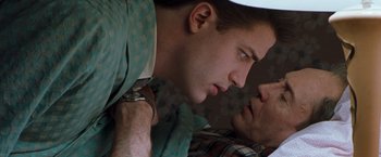 Movie still from “Blast from the Past” (1999), directed by Hugh Wilson – A man laying in bed with another man looking at him; Close Up shot, Overhead angle