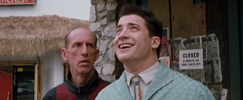 Movie still from “Blast from the Past” (1999), directed by Hugh Wilson – A man in a suit and tie standing next to another man in a jacket; Close Up shot, Low angle