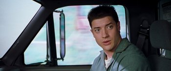 Movie still from “Blast from the Past” (1999), directed by Hugh Wilson – A person sitting in a car; Close Up shot, Over the shoulder angle