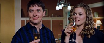 Movie still from “Blast from the Past” (1999), directed by Hugh Wilson – A man and a woman drinking wine at a party; Medium shot, Over the shoulder angle