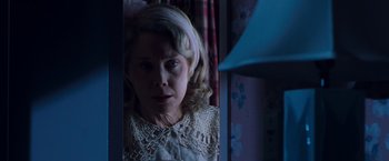 Movie still from “Blast from the Past” (1999), directed by Hugh Wilson – A woman in a white dress looking at the camera; Close Up shot, Low angle