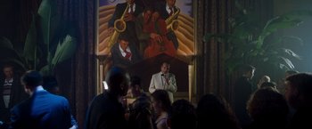 Movie still from “Blast from the Past” (1999), directed by Hugh Wilson – A group of people standing in front of a painting; Wide shot, Low angle