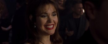 Movie still from “Blast from the Past” (1999), directed by Hugh Wilson – A person with a smile on their face; Close Up shot, Over the shoulder angle