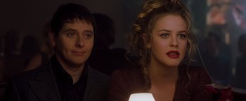 Movie still from “Blast from the Past” (1999), directed by Hugh Wilson – A man and a woman sitting next to each other; Close Up shot, Over the shoulder angle