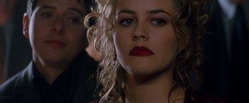 Movie still from “Blast from the Past” (1999), directed by Hugh Wilson – A person with curly blonde hair; Close Up shot, Over the shoulder angle
