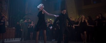 Movie still from “Blast from the Past” (1999), directed by Hugh Wilson – A man and a woman are dancing in front of a crowd; Wide shot, Low angle