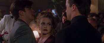 Movie still from “Blast from the Past” (1999), directed by Hugh Wilson – A woman with red lipstick is standing next to a man; Close Up shot, Over the shoulder angle