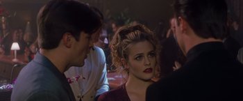 Movie still from “Blast from the Past” (1999), directed by Hugh Wilson – A woman with red lipstick is sitting next to a man; Close Up shot, Over the shoulder angle