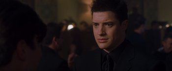 Movie still from “Blast from the Past” (1999), directed by Hugh Wilson – A person wearing a suit and tie; Close Up shot, Over the shoulder angle