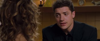 Movie still from “Blast from the Past” (1999), directed by Hugh Wilson – A man in a black suit is talking to a woman in a black suit; Close Up shot, Over the shoulder angle