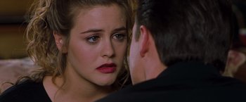 Movie still from “Blast from the Past” (1999), directed by Hugh Wilson – A woman looking at a man in the mirror; Close Up shot, Over the shoulder angle