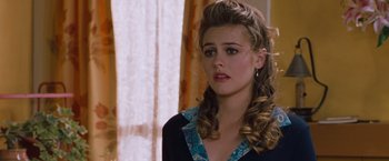 Movie still from “Blast from the Past” (1999), directed by Hugh Wilson – A young woman with long blonde hair wearing a black shirt; Close Up shot, Over the shoulder angle