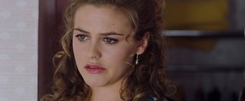 Movie still from “Blast from the Past” (1999), directed by Hugh Wilson – A person with curly brown hair; Close Up shot, Over the shoulder angle