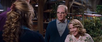 Movie still from “Blast from the Past” (1999), directed by Hugh Wilson – A group of people standing next to each other in a room; Medium shot, Over the shoulder angle