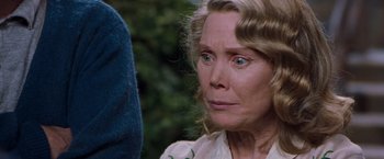 Movie still from “Blast from the Past” (1999), directed by Hugh Wilson – An older woman with green eyes stares at the camera; Close Up shot, Low angle