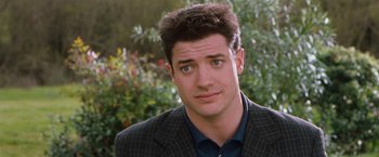 Movie still from “Blast from the Past” (1999), directed by Hugh Wilson – A person wearing a suit and tie; Close Up shot, Over the shoulder angle