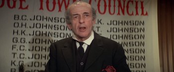 Movie still from “Blazing Saddles” (1974), directed by Mel Brooks – An older man wearing a suit and tie; Close Up shot, Low angle