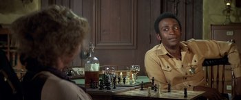 Movie still from “Blazing Saddles” (1974), directed by Mel Brooks – Two people sitting at a table with a chess board; Close Up shot, Over the shoulder angle