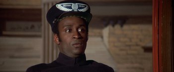 Movie still from “Blazing Saddles” (1974), directed by Mel Brooks – A man wearing a uniform and a hat; Close Up shot, Low angle