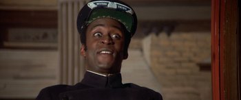 Movie still from “Blazing Saddles” (1974), directed by Mel Brooks – A person wearing a uniform and a hat; Close Up shot, Low angle