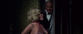 Movie still from “Blazing Saddles” (1974), directed by Mel Brooks – A man and a woman are standing next to each other; Medium shot, Over the shoulder angle