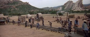 Movie still from “Blazing Saddles” (1974), directed by Mel Brooks – A group of men working on a train track; Extreme Wide shot, High angle