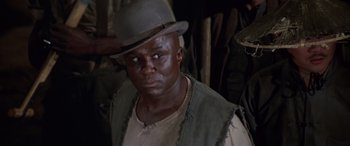 Movie still from “Blazing Saddles” (1974), directed by Mel Brooks – A man wearing a hat and looking at the camera; Close Up shot, Low angle