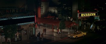 Movie still from “Blazing Saddles” (1974), directed by Mel Brooks – A group of people standing on a street at night; Extreme Wide shot, High angle