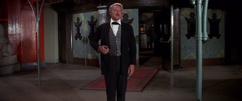 Movie still from “Blazing Saddles” (1974), directed by Mel Brooks – An older man wearing a suit and tie; Medium shot, Low angle