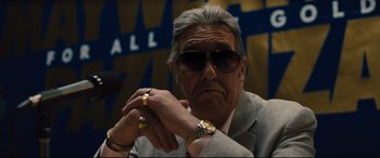 Movie still from “Bleed for This” (2016), directed by Ben Younger – An older man wearing a suit and sunglasses; Close Up shot, Low angle