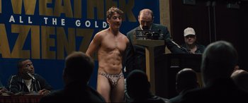 Movie still from “Bleed for This” (2016), directed by Ben Younger – A man in underwear standing in front of an audience; Medium shot, Over the shoulder angle