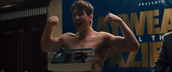 Movie still from “Bleed for This” (2016), directed by Ben Younger – A shirtless man standing in front of a weight scale; Medium shot, Low angle