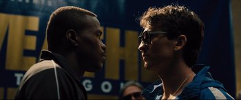 Movie still from “Bleed for This” (2016), directed by Ben Younger – Two young men face each other in front of a crowd of onlookers; Close Up shot, Over the shoulder angle