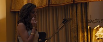 Movie still from “Bleed for This” (2016), directed by Ben Younger – A woman is talking into a microphone in front of a microphone stand; Medium shot, Low angle