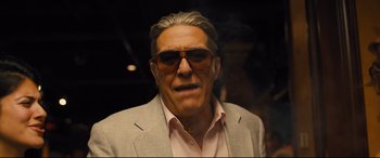 Movie still from “Bleed for This” (2016), directed by Ben Younger – An older man wearing sunglasses and a suit; Close Up shot, Low angle