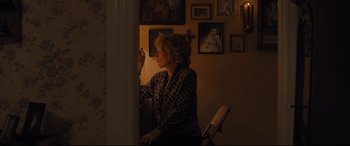 Movie still from “Bleed for This” (2016), directed by Ben Younger – A woman sitting in a chair in a room; Medium shot, High angle
