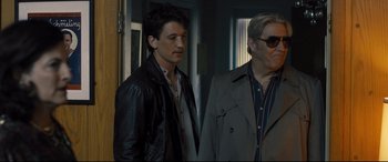 Movie still from “Bleed for This” (2016), directed by Ben Younger – A man standing next to another man in a room; Medium shot, Over the shoulder angle