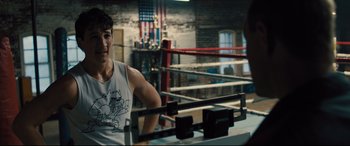 Movie still from “Bleed for This” (2016), directed by Ben Younger – A man sitting in the corner of a boxing ring; Medium shot, Over the shoulder angle
